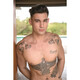 Tatooed brunette male topless
