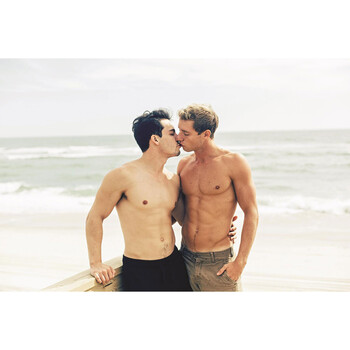 Two males topless kissing