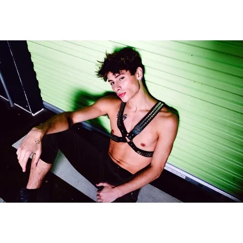 Male model wearing leather harness front view