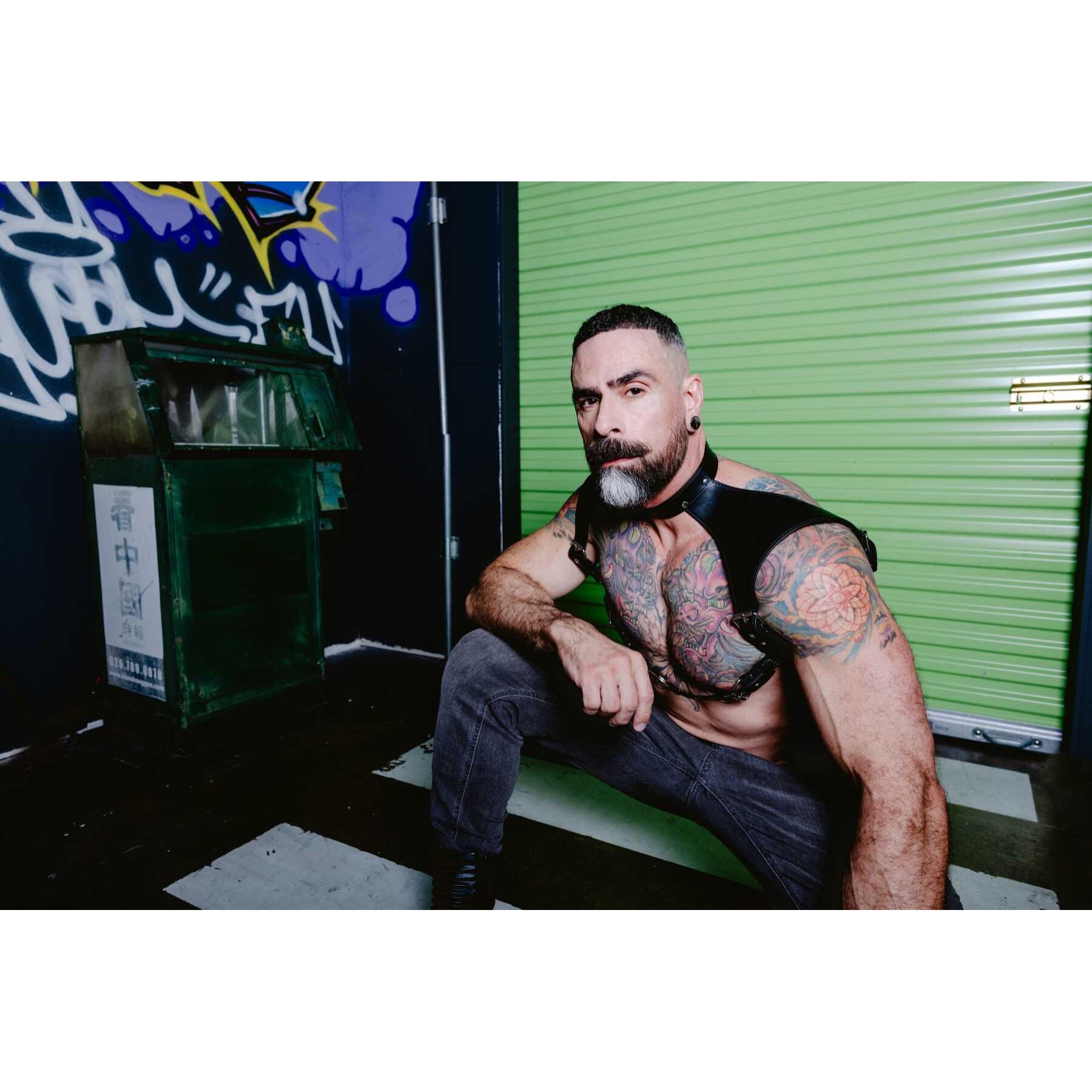 Male posed wearing leather neck harness front view