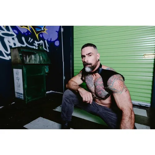 Male posed wearing leather neck harness front view